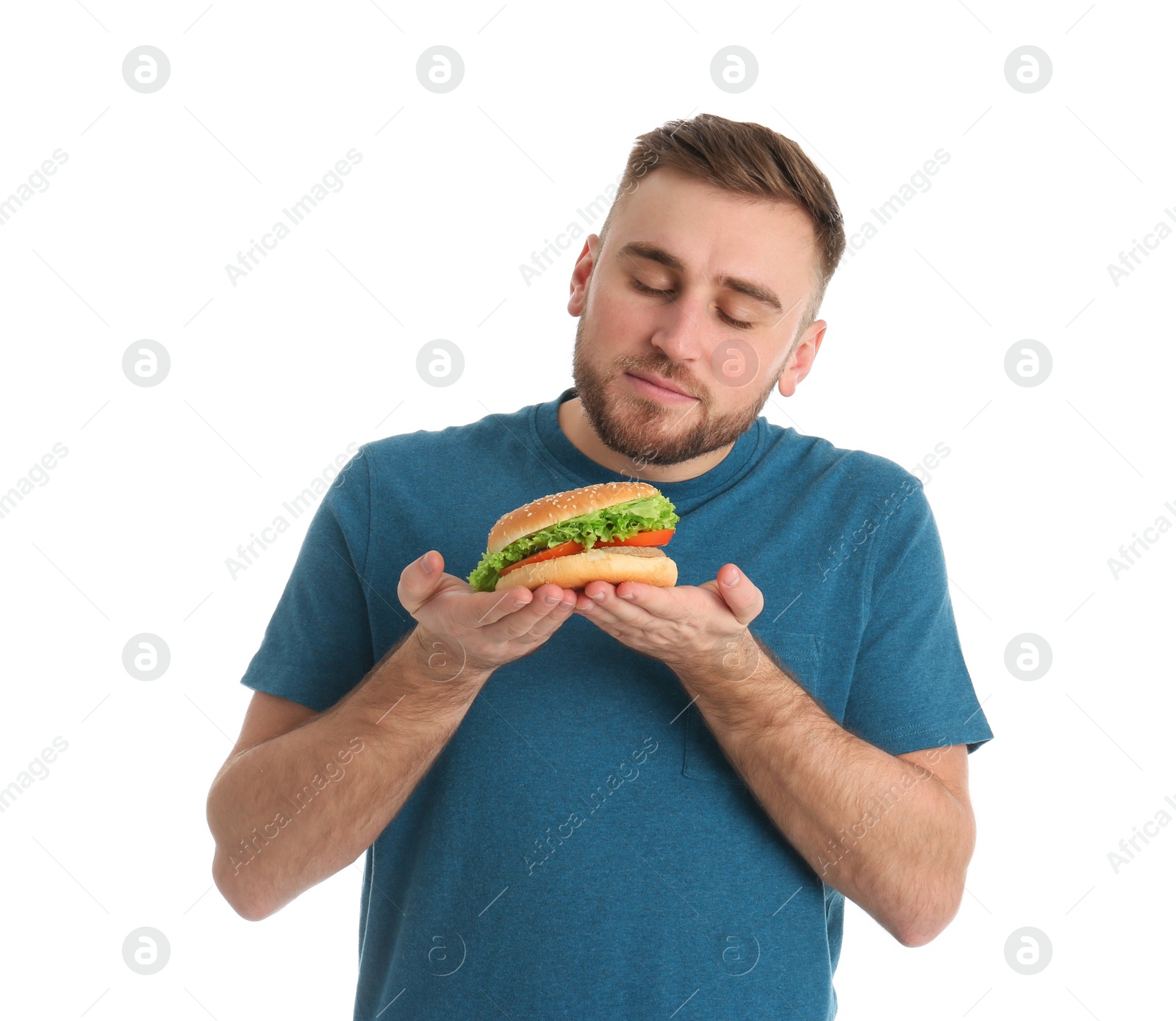 Photo of Young man with tasty burger on white background