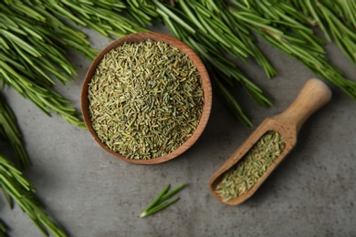 Photo of Dried rosemary and fresh twigs on grey background, flat lay