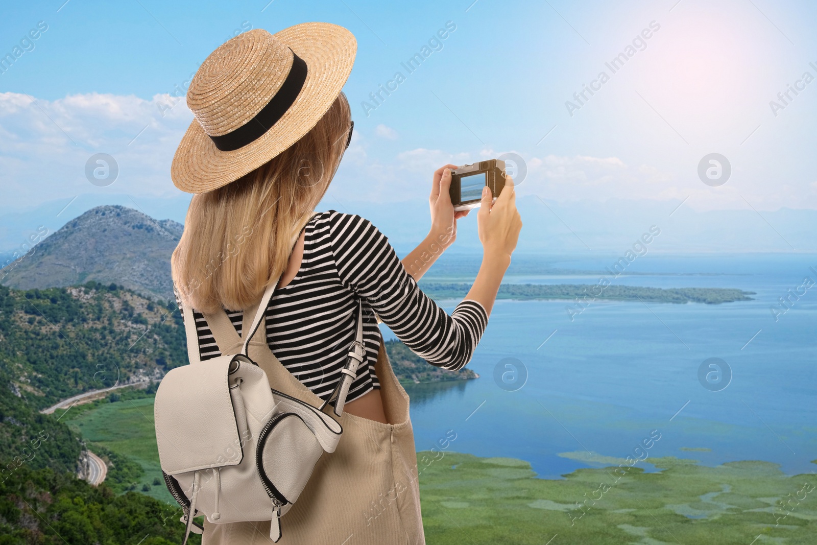 Image of Traveler taking photo of sea during summer vacation trip. Space for text