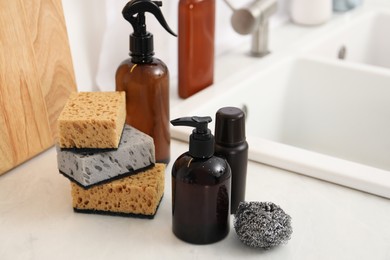 Photo of Different cleaning supplies on countertop in kitchen