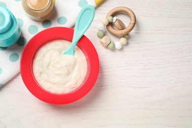 Photo of Flat lay composition with healthy baby food on white wooden table, space for text