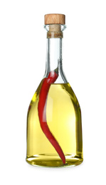 Photo of Cooking oil with chili pepper in glass bottle isolated on white