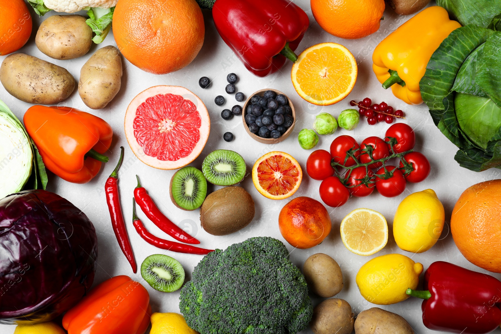 Photo of Fresh products rich in vitamin C on light table, flat lay