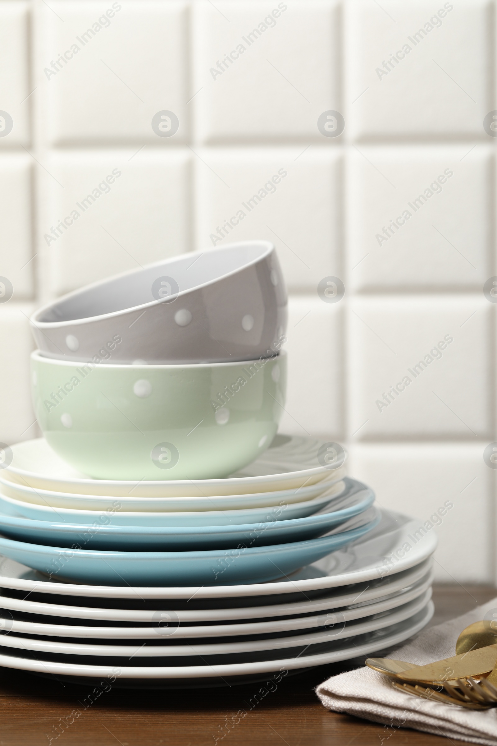 Photo of Beautiful ceramic dishware and cutlery on wooden table