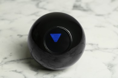 Photo of Magic eight ball on white marble table