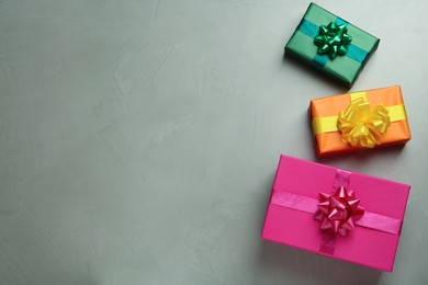 Photo of Many colorful gift boxes on light grey table, flat lay. Space for text