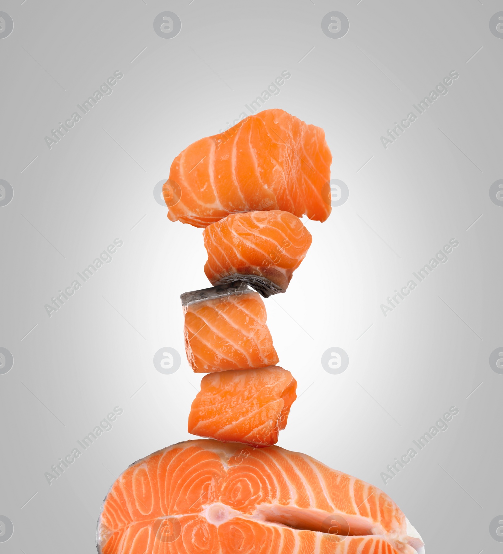 Image of Stack of cut fresh salmon on light grey background