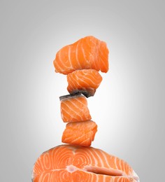 Image of Stack of cut fresh salmon on light grey background