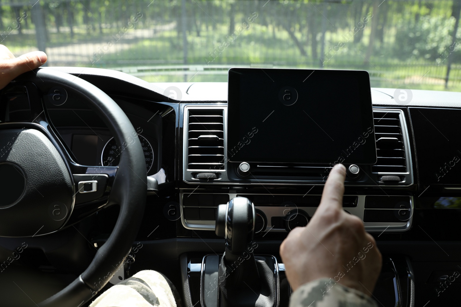 Photo of Soldier using tablet in car, closeup view