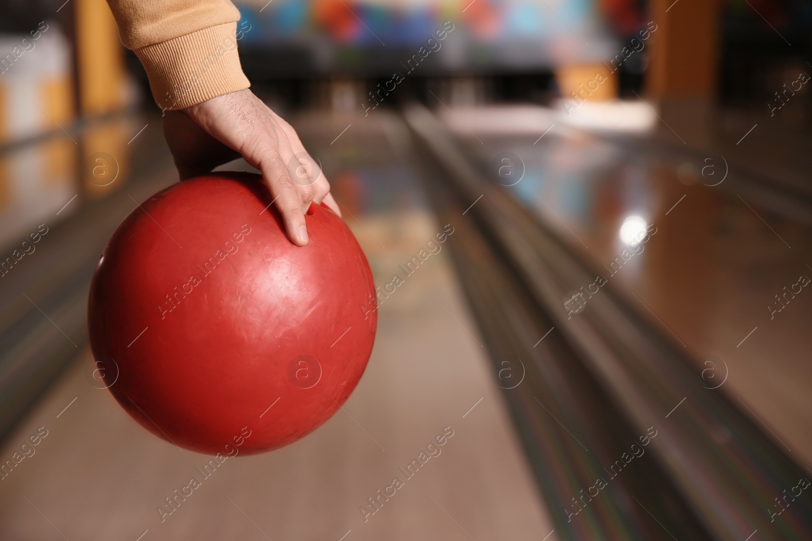 Photo of Man with ball in bowling club, closeup. Space for text