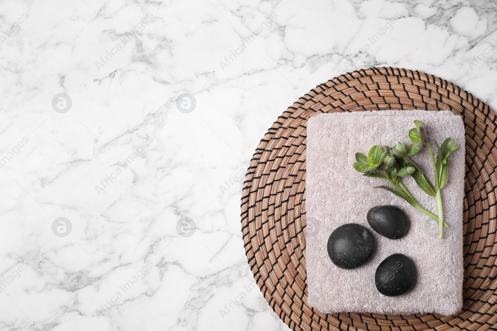 Photo of Flat lay composition with spa stones, towel and space for text on white marble background