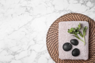 Photo of Flat lay composition with spa stones, towel and space for text on white marble background