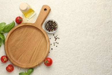 Photo of Cutting board, basil, oil, spices and tomatoes on white textured table, flat lay. Space for text