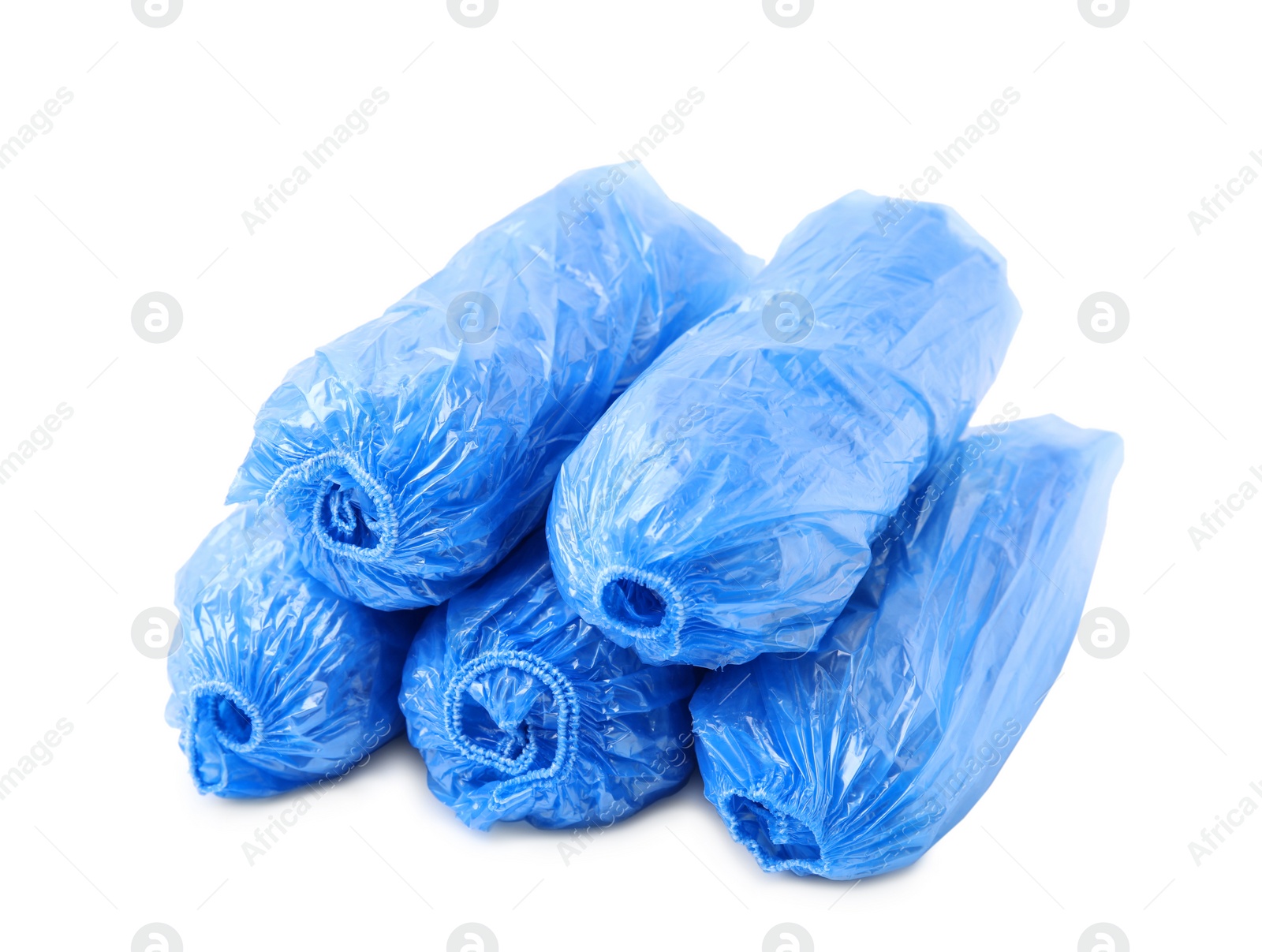 Photo of Many rolled blue shoe covers isolated on white