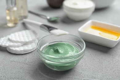 Photo of Spirulina facial mask and brush on light grey table