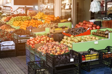 Many fruits and berries in crates selling near store outdoors