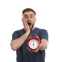 Photo of Emotional overslept man with alarm clock on white background. Being late concept