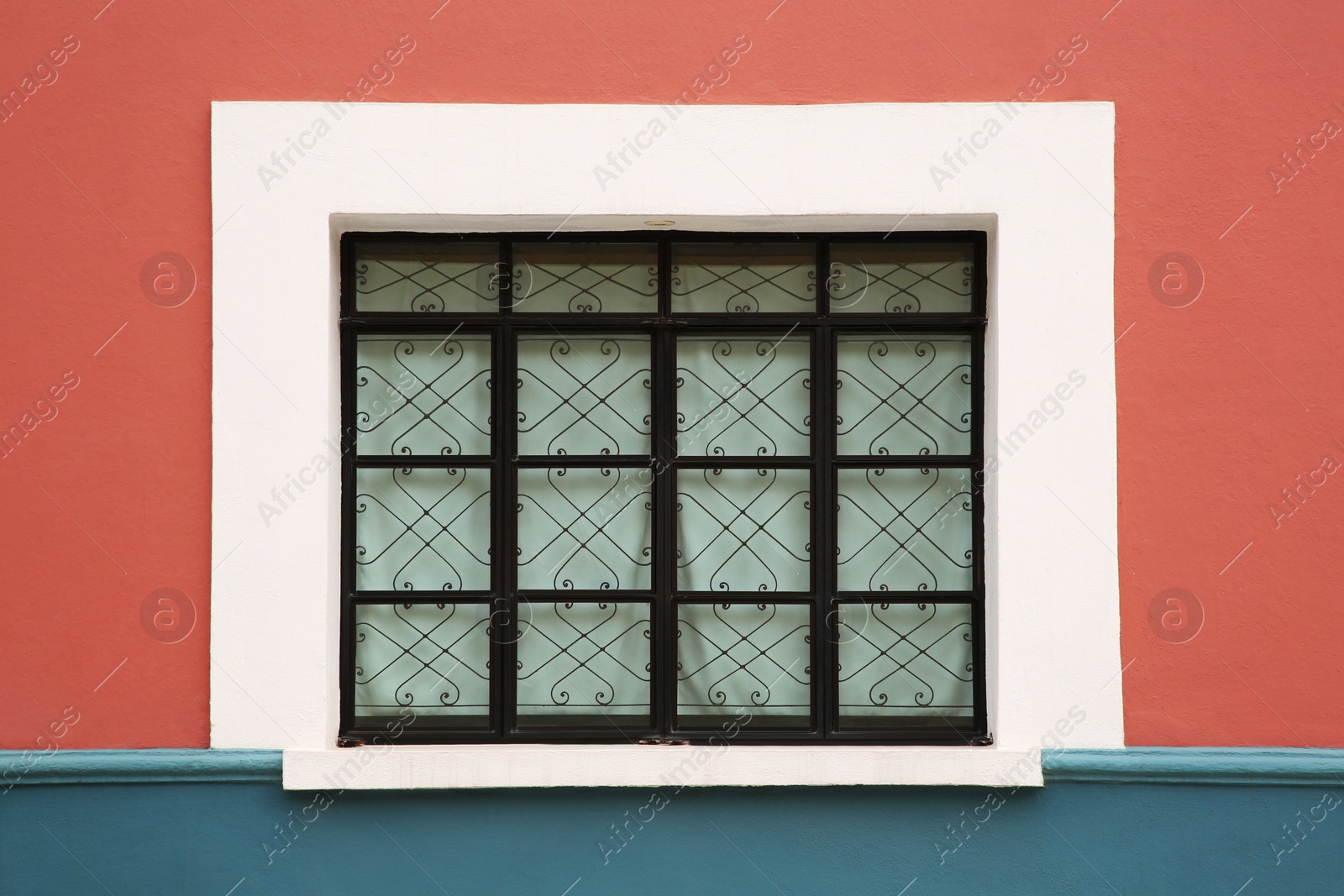 Photo of Colorful building with beautiful window and steel grilles