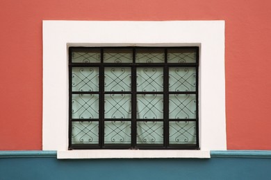 Photo of Colorful building with beautiful window and steel grilles