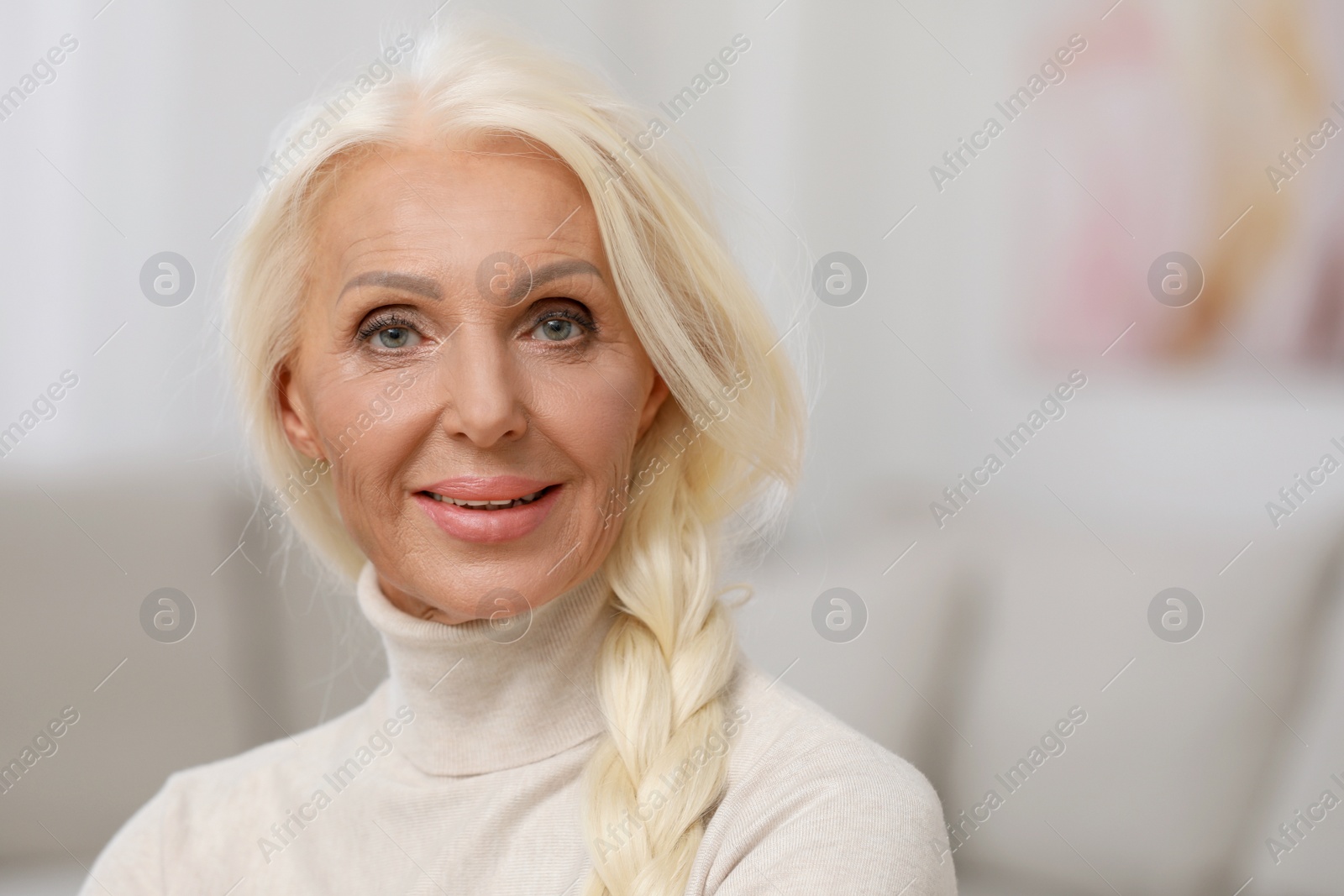 Photo of Portrait of happy mature woman indoors. Space for text