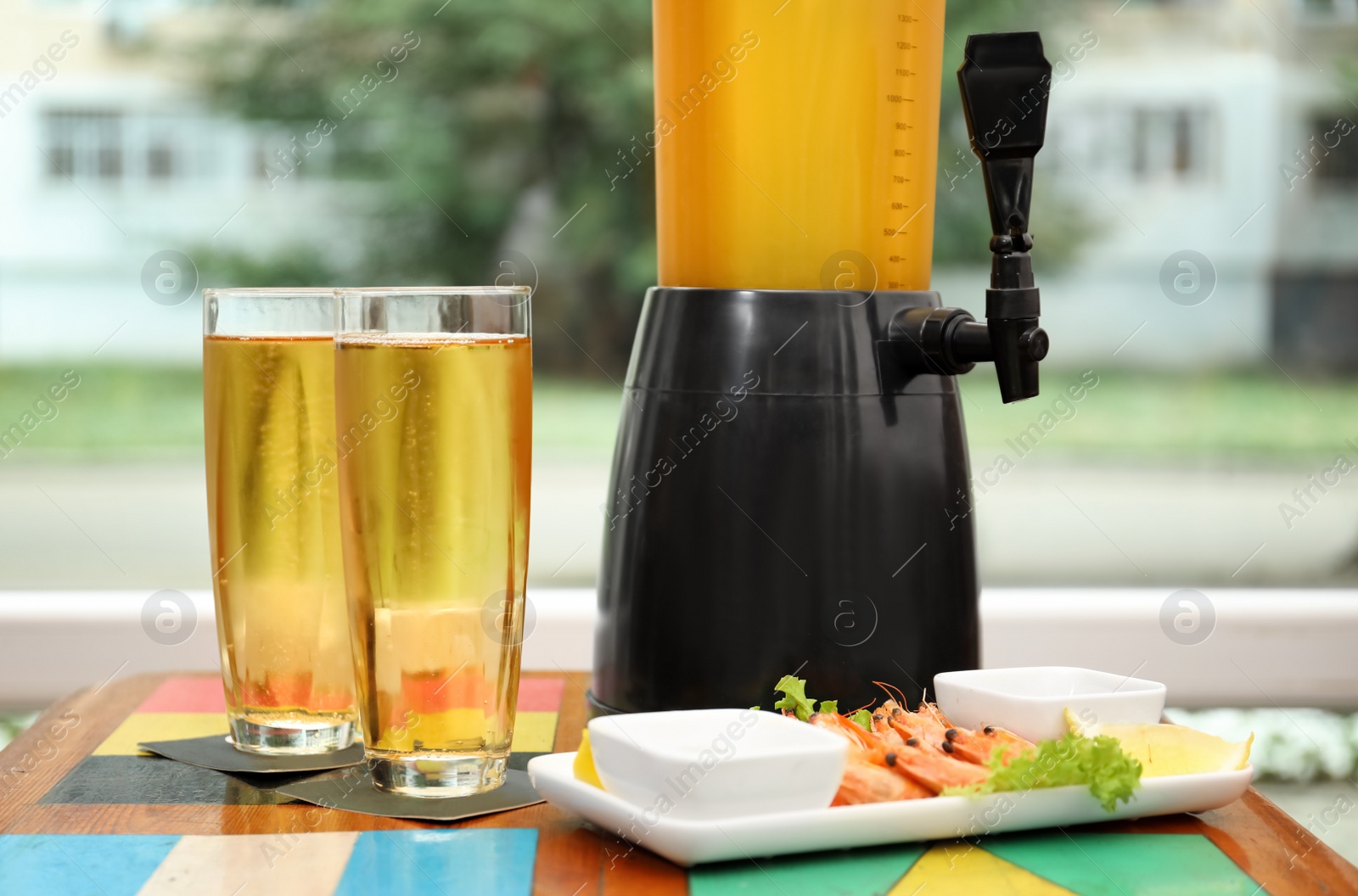 Photo of Glasses with cold beer and snack on table