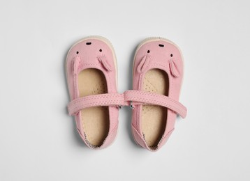Photo of Cute baby shoes on white background, flat lay