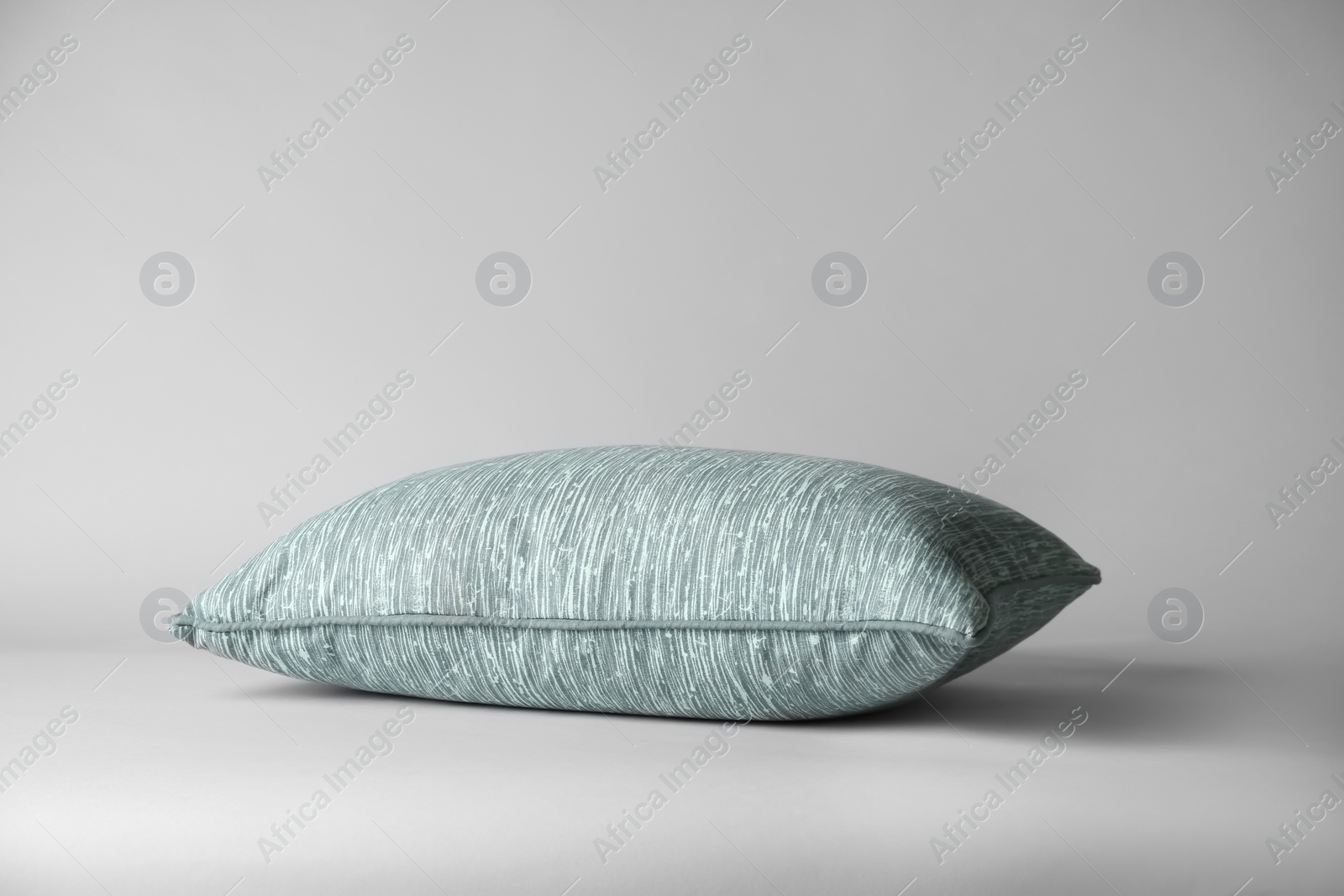 Photo of Soft decorative pillow on light background