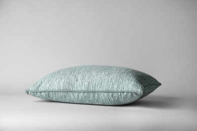 Photo of Soft decorative pillow on light background