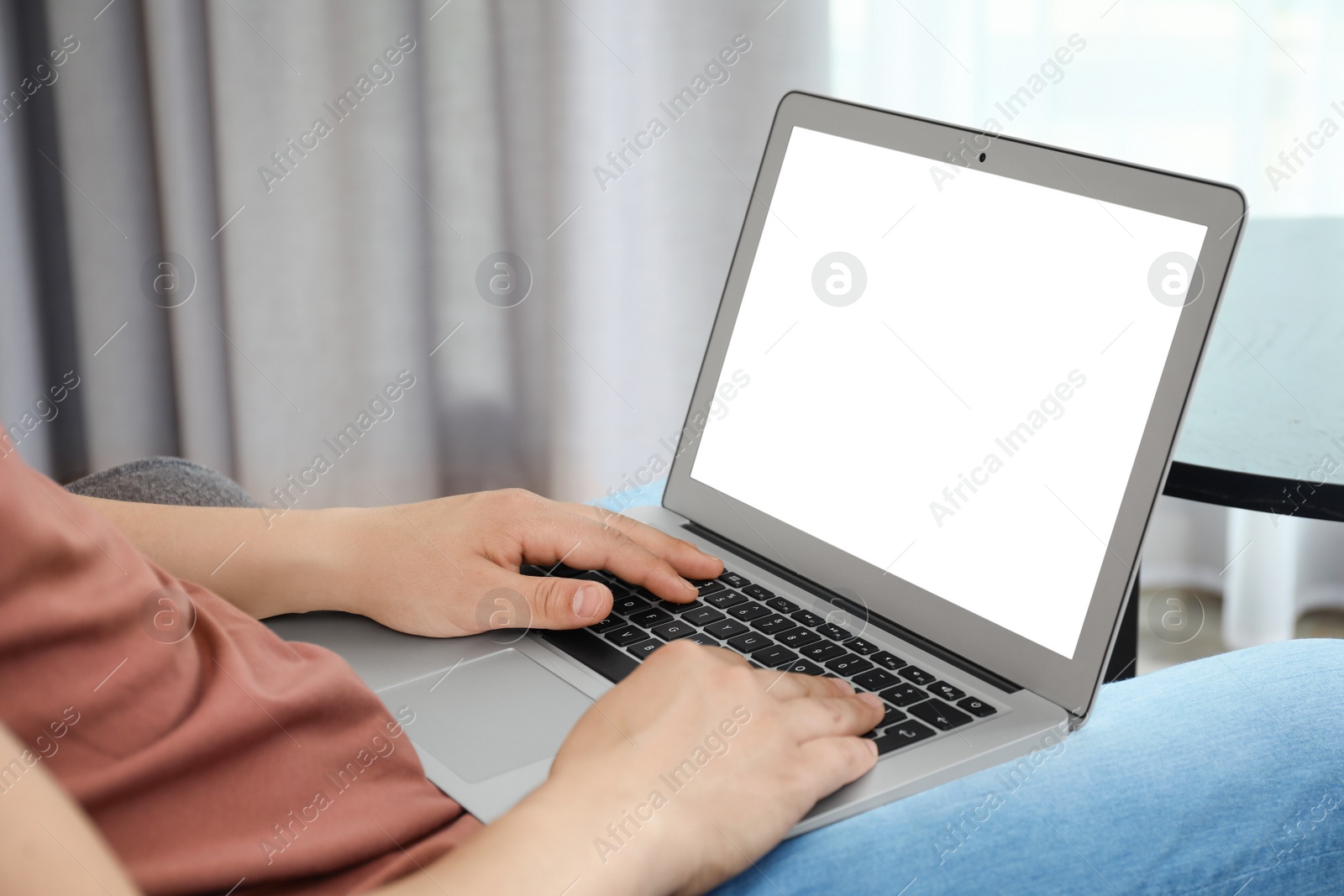 Photo of Man in casual clothes with laptop indoors