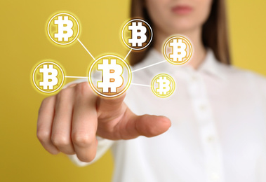 Fintech concept. Woman using virtual screen with bitcoin symbols