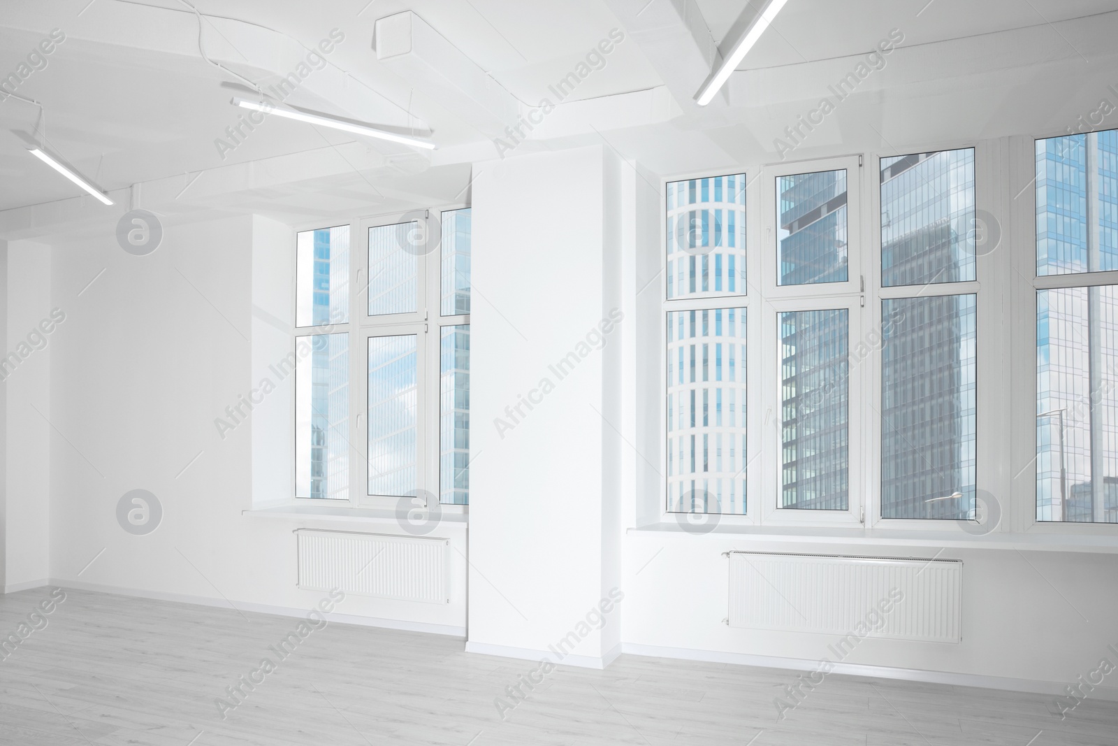 Photo of New empty room with clean windows and white wall