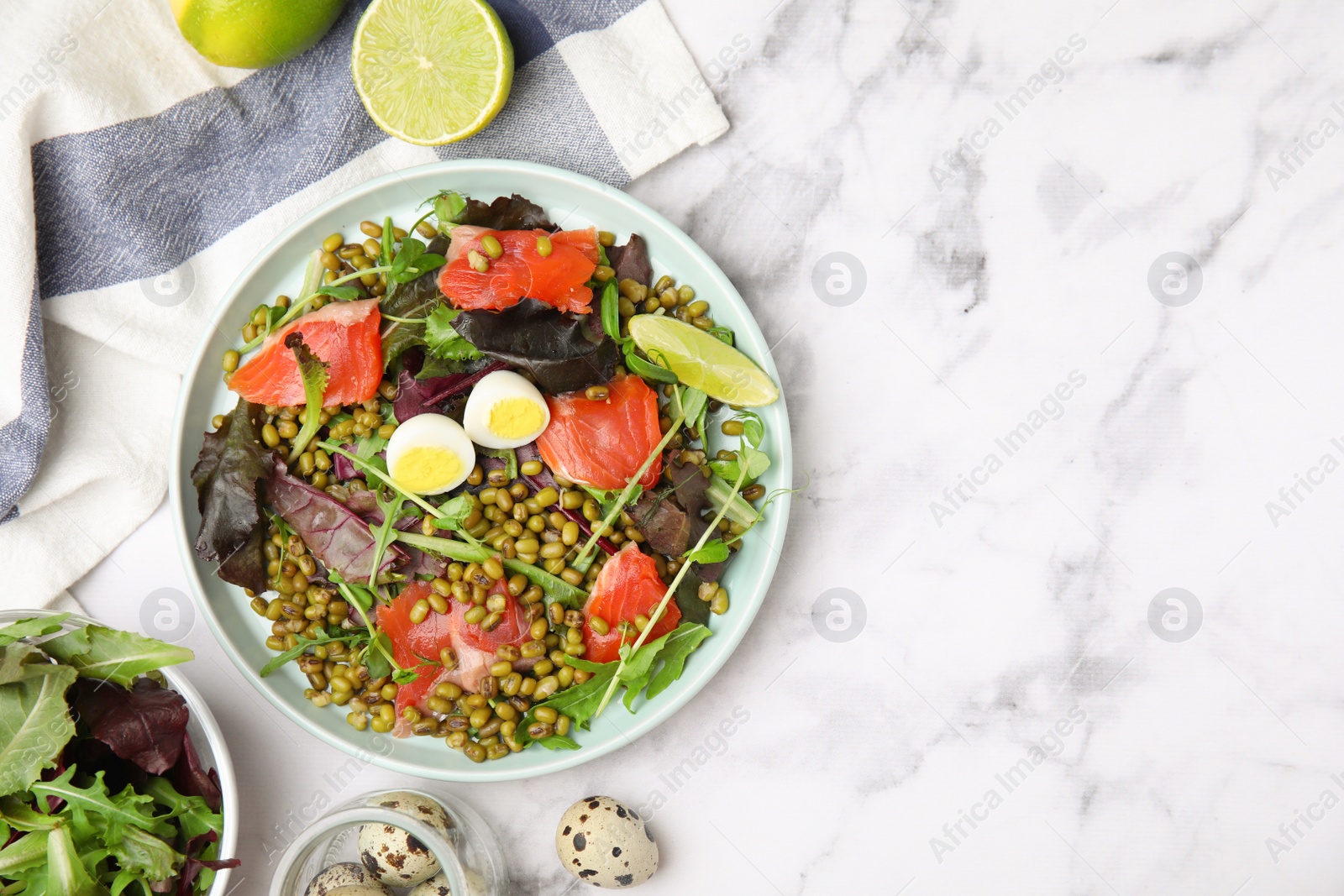 Photo of Plate of salad with mung beans on white marble table, flat lay. Space for text