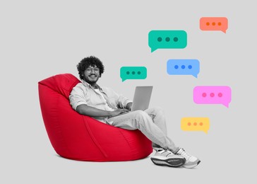 Image of Smiling man with laptop sitting on beanbag chair against white background. Dialogue bubbles near him