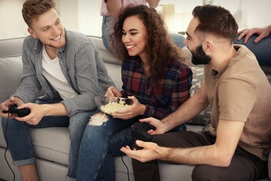 Emotional friends playing video games at home