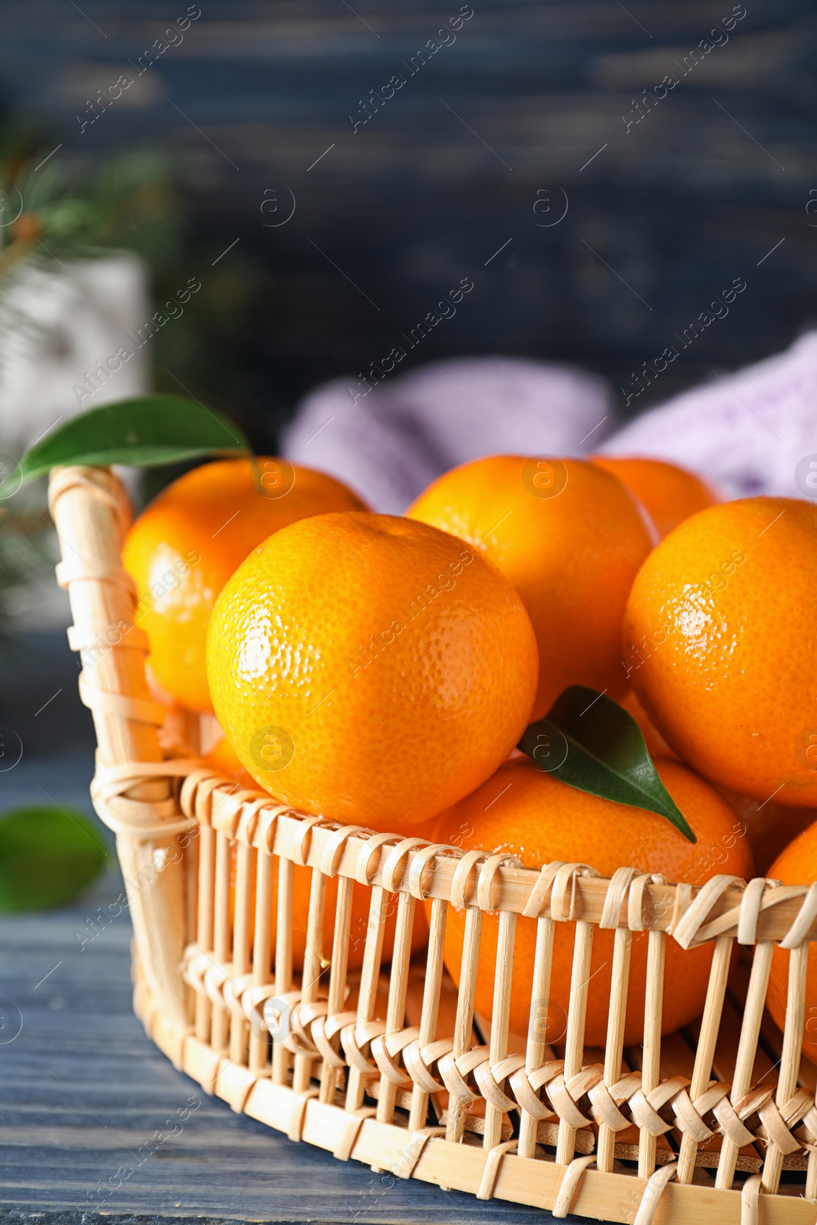 Photo of Tasty fresh tangerines on blue wooden table. Christmas celebration