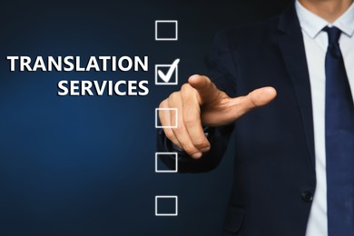 Image of Translation Services. Man pointing and checkbox on virtual screen against blue background, closeup