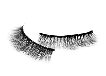 Pair of magnetic eyelashes on white background