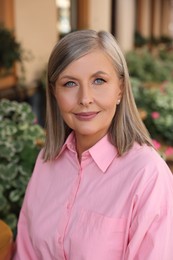 Portrait of beautiful smiling senior woman outdoors