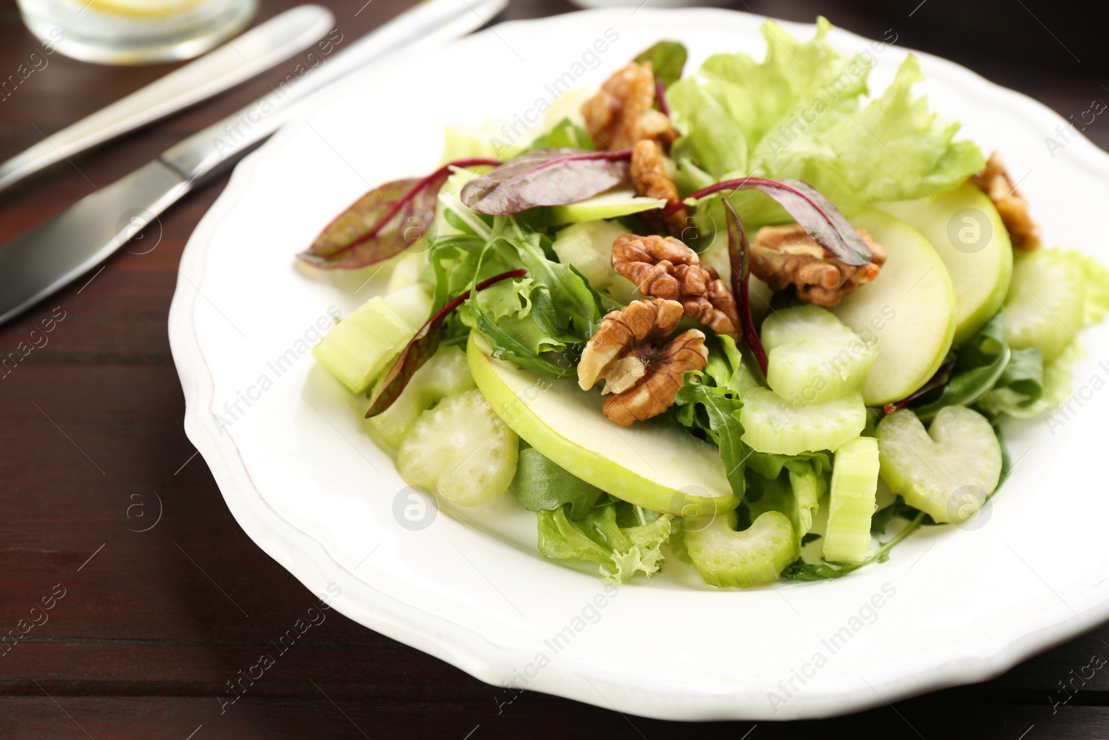 Photo of Delicious fresh celery salad on wooden table, closeup