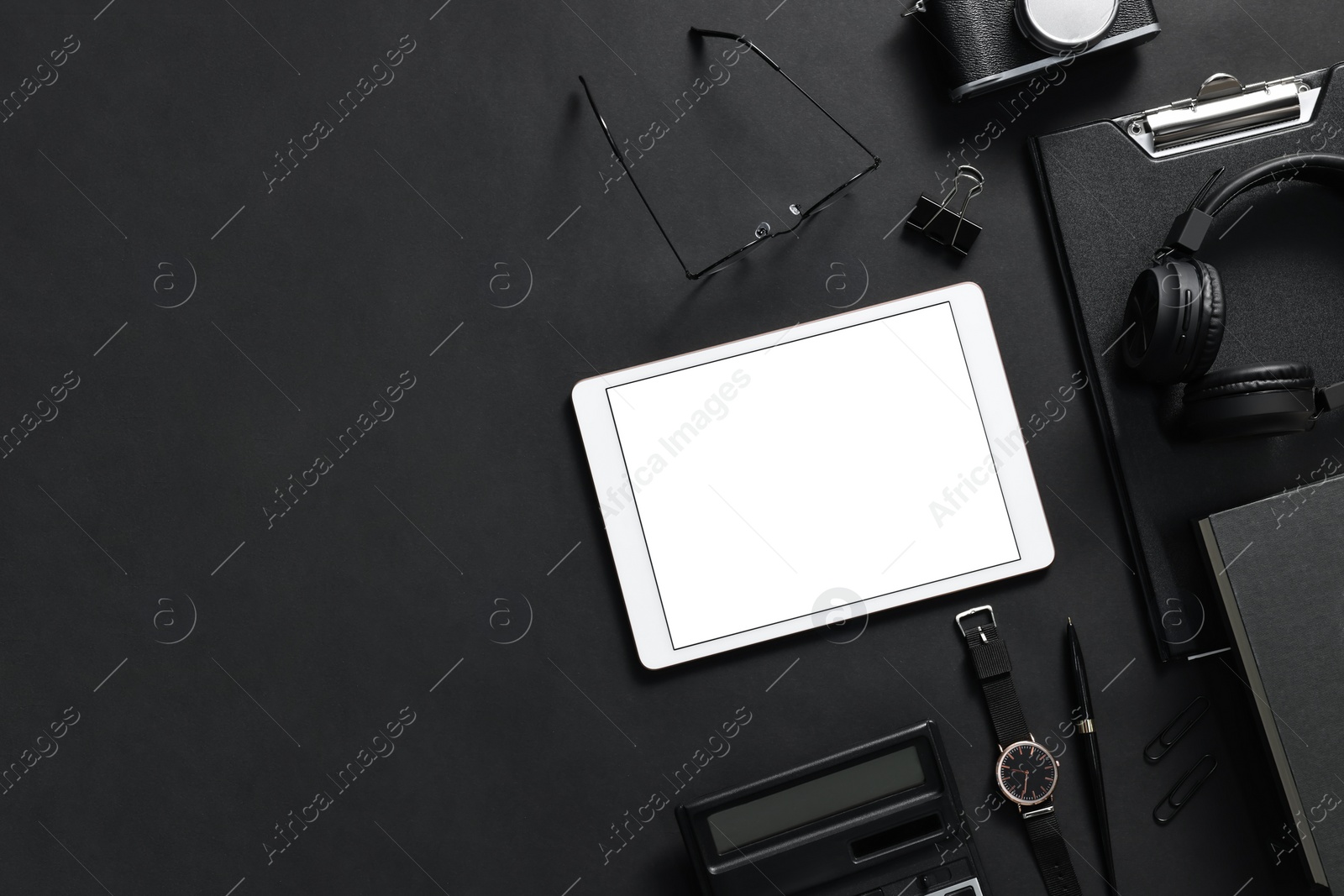 Photo of Flat lay composition with modern tablet on black background. Space for text