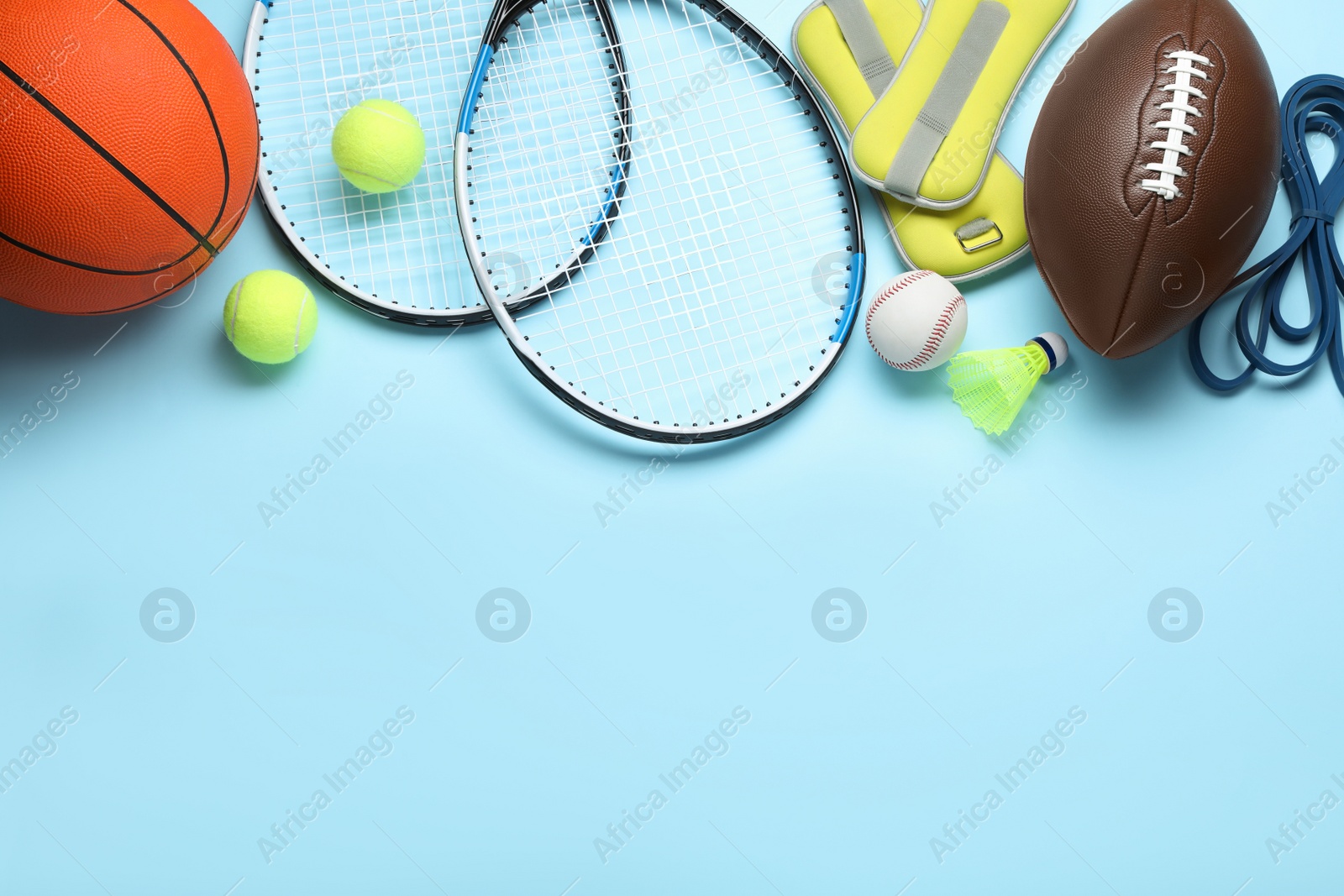 Photo of Set of different sports equipment on light blue background, flat lay. Space for text