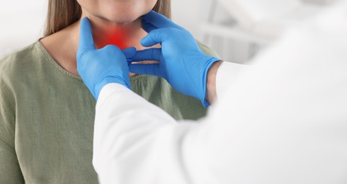 Endocrinologist examining thyroid gland of patient at hospital, closeup. Banner design