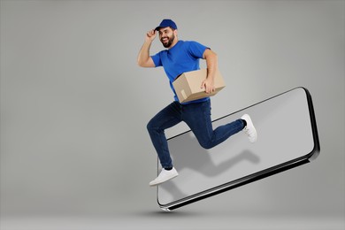 Courier with parcel jumping out from huge smartphone on grey background. Delivery service