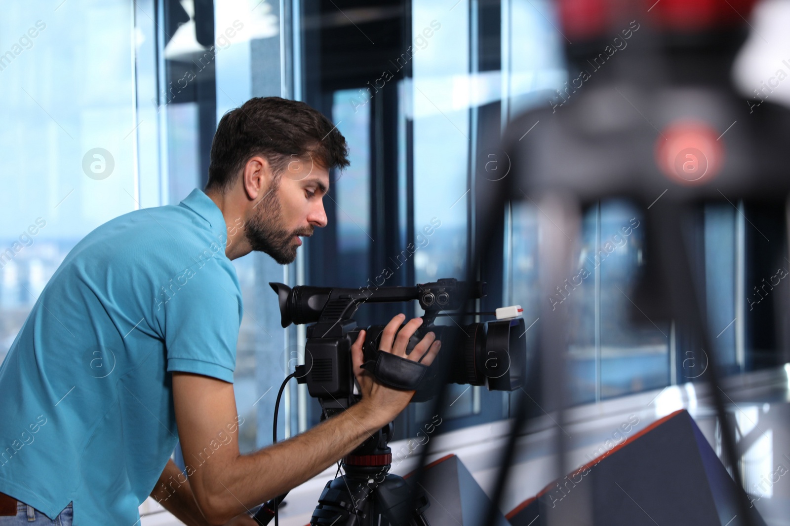 Photo of Professional video camera operator working in studio