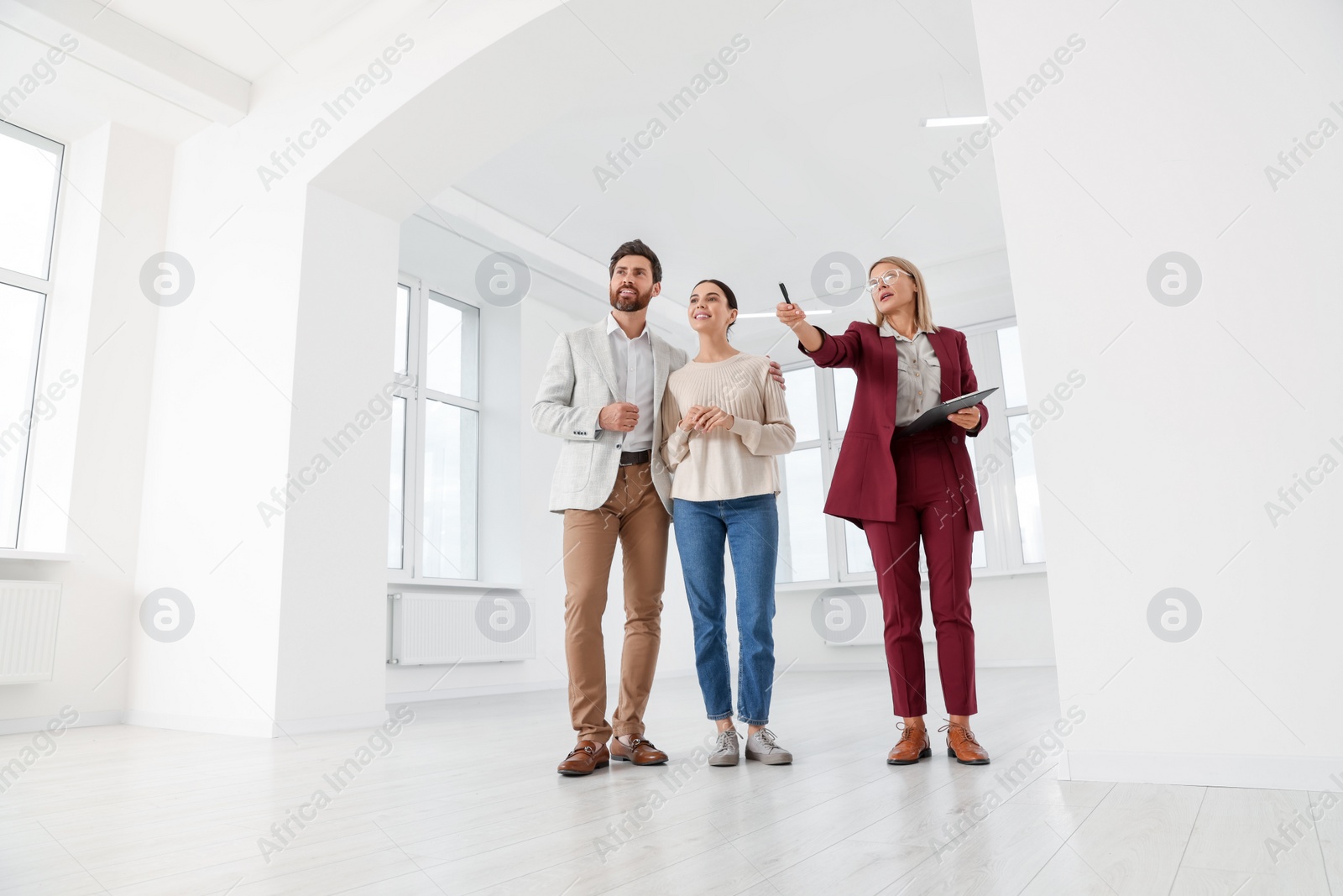 Photo of Real estate agent showing new apartment to couple