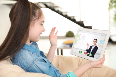 Distance learning, studying at home. Girl having online school lesson during quarantine and lockdown due to Covid-19 pandemic