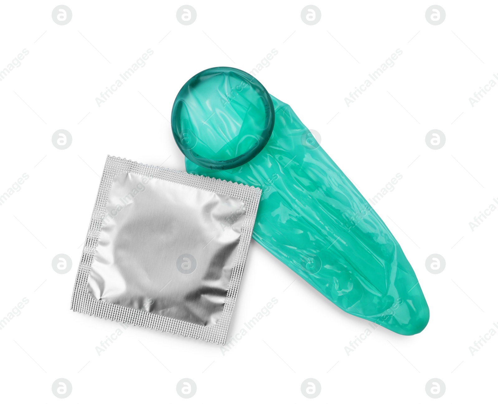 Photo of Unrolled condom and package on white background, top view. Safe sex