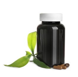 Photo of Bottle with vitamin capsules and green leaves on white background