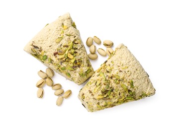 Photo of Pieces of tasty halva with pistachios on white background, top view