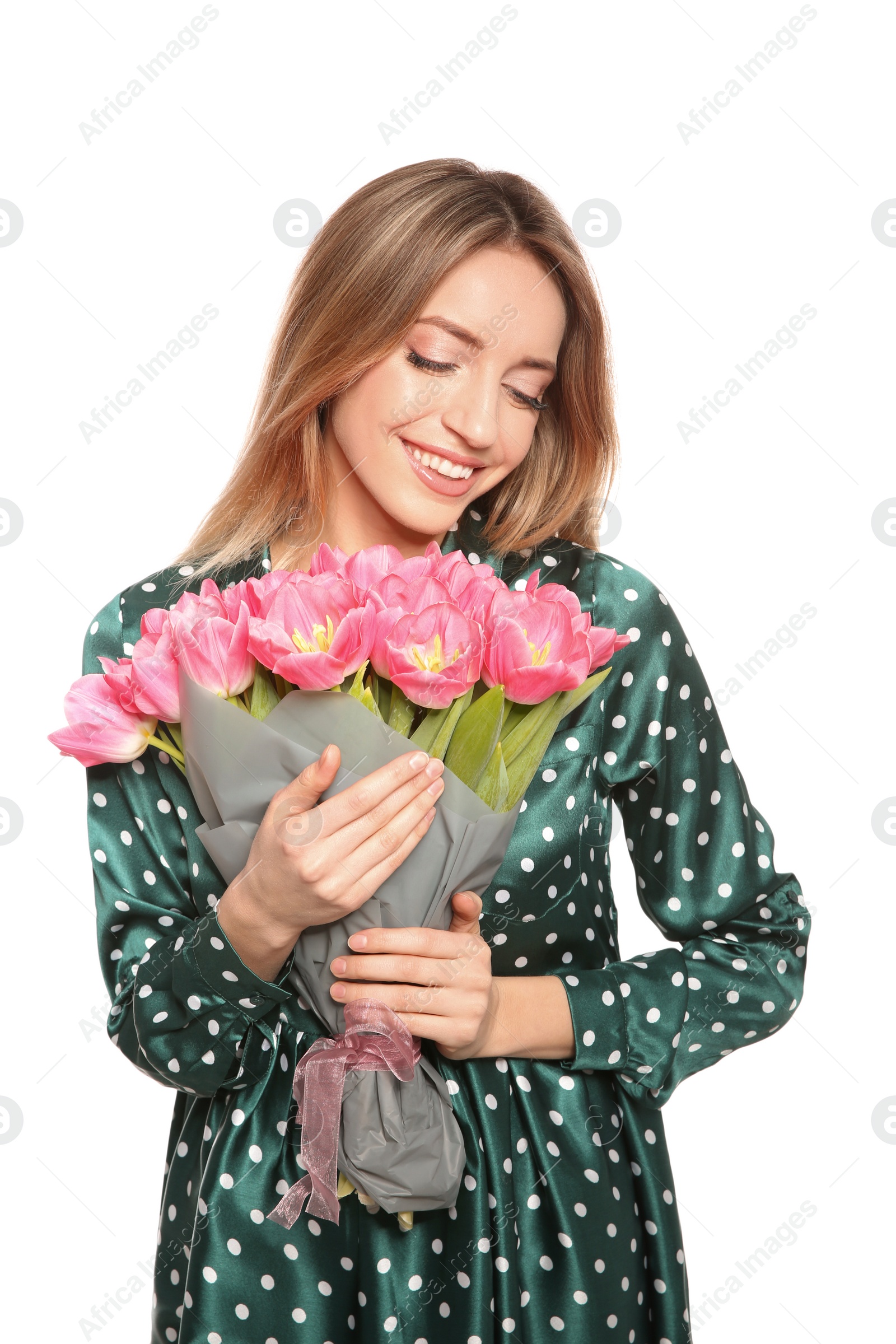 Photo of Portrait of smiling young girl with beautiful tulips on white background. International Women's Day